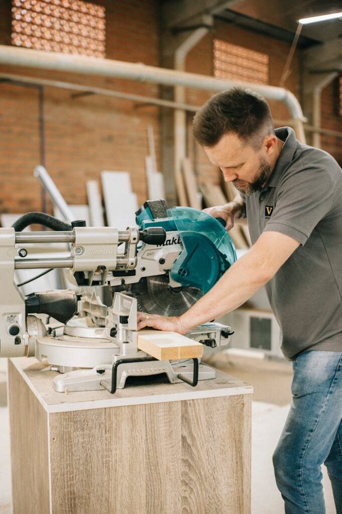 Carpenter using a circular saw in a workshop setting, focusing precision.